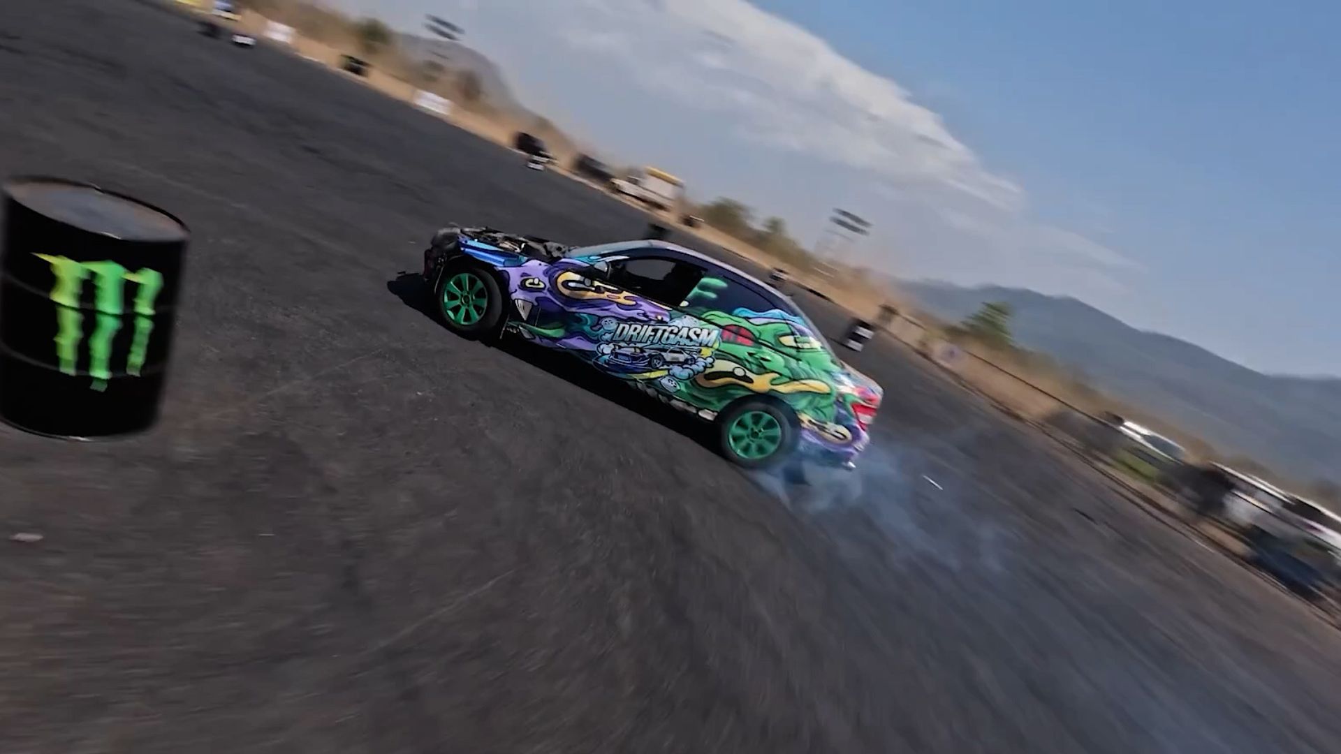 High-speed FPV drone chasing a drift car at a motorsport event
